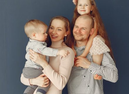 A joyful family portrait showcasing parents and their two children, expressing love and togetherness.